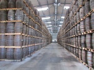 Warehouse filled with whisky laden barrels